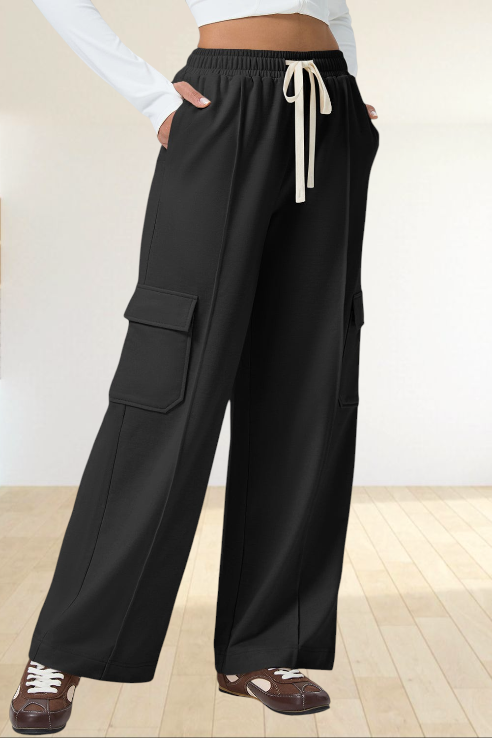 Baya Wear black high-waisted wide-leg cargo sweatpants with side patch pockets and an adjustable drawstring waist.