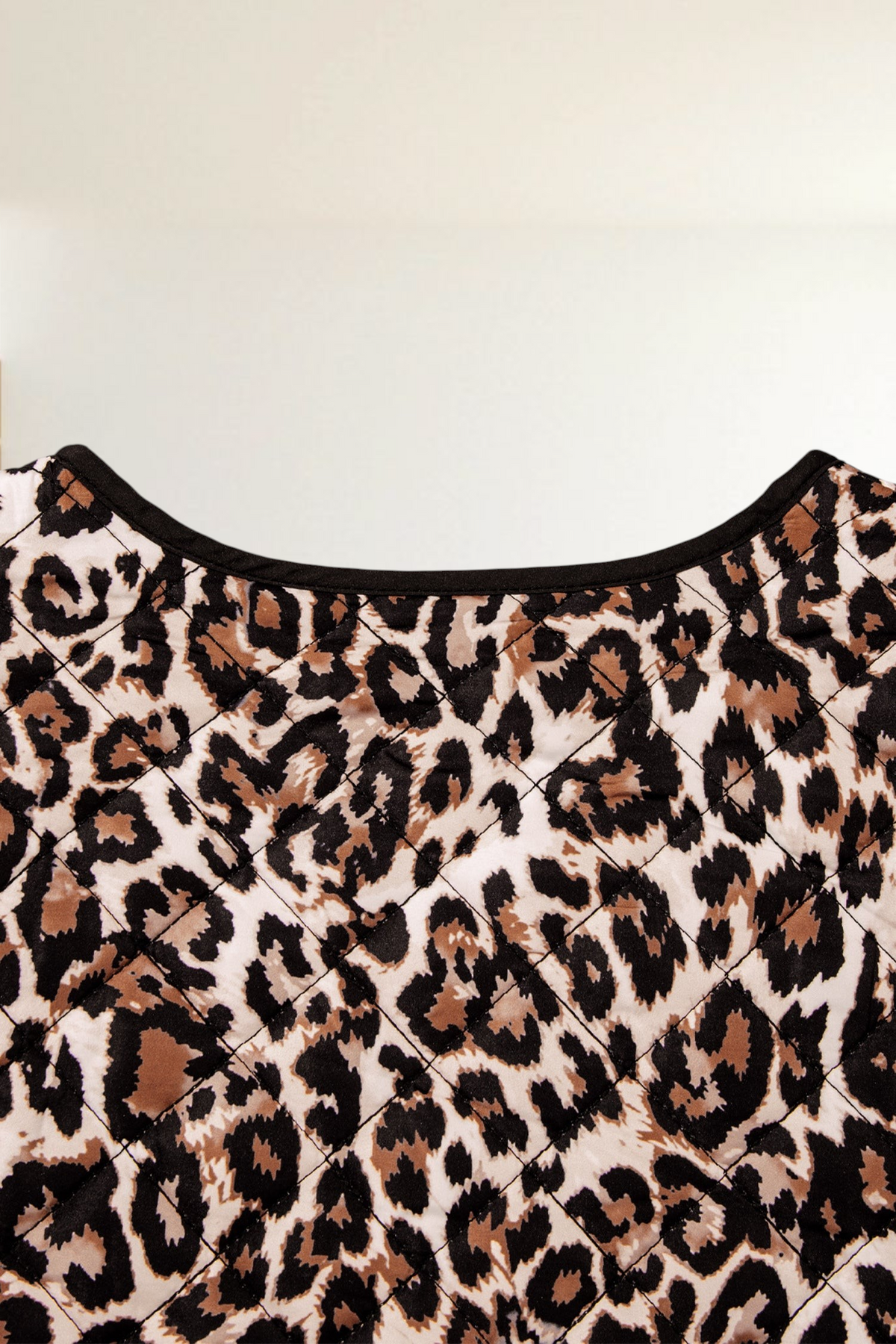 Baya Wear quilted jacket featuring a brown and black leopard print pattern with black trim detail
