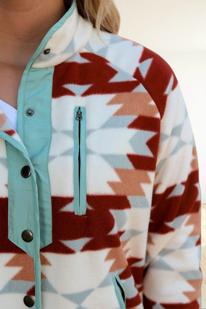 Baya Wear fiery red and cream Aztec pattern fleece jacket with light blue trim and snap button closure