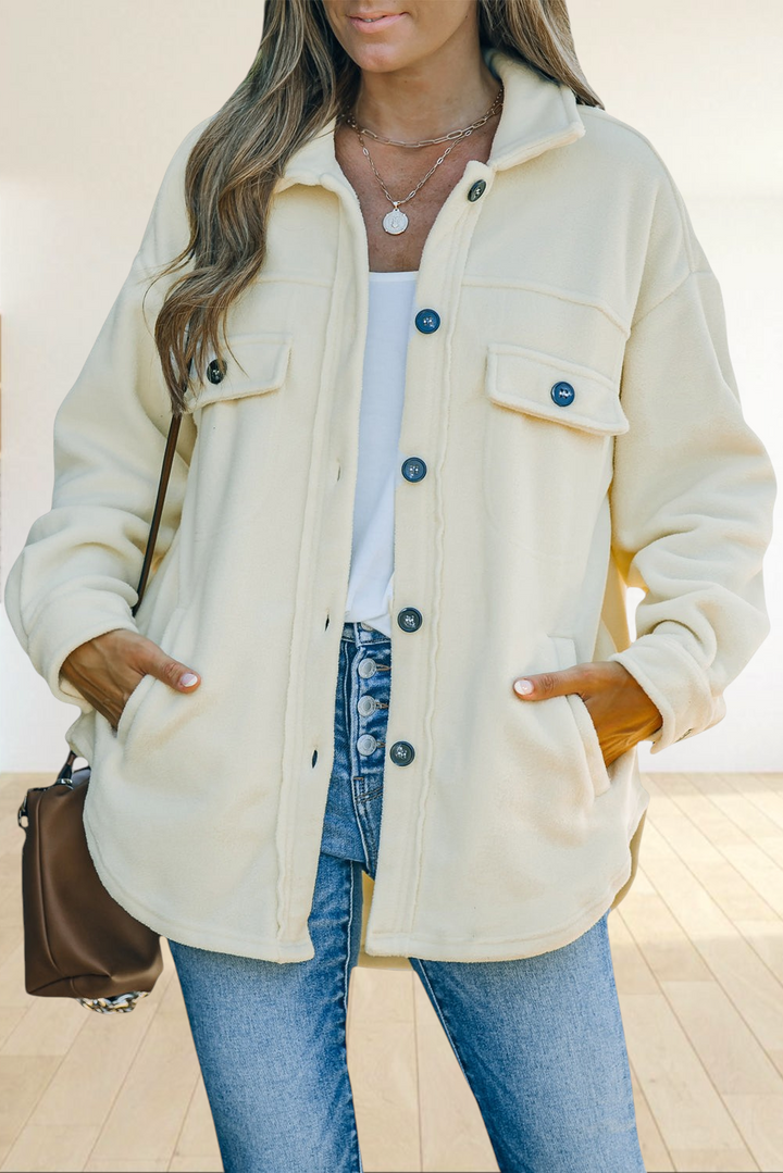 Baya Wear beige fleece button-down shacket with chest pockets worn over a white top and blue jeans