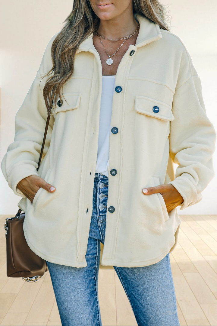 Baya Wear beige fleece shirt jacket with a turn-down collar, button front, and chest pockets worn over blue jeans.