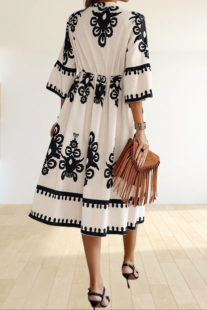 Baya Wear beige midi dress with black geometric print, V-neck, 3/4 sleeves, and tiered skirt, back view.