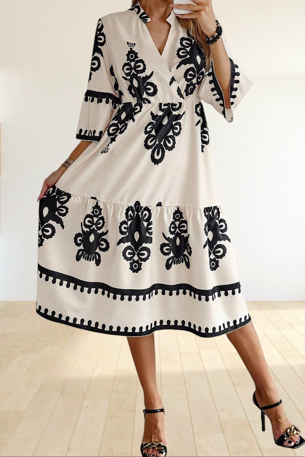 Baya Wear beige midi dress with black western geometric print, V-neckline, 3/4 sleeves, and tiered skirt design.