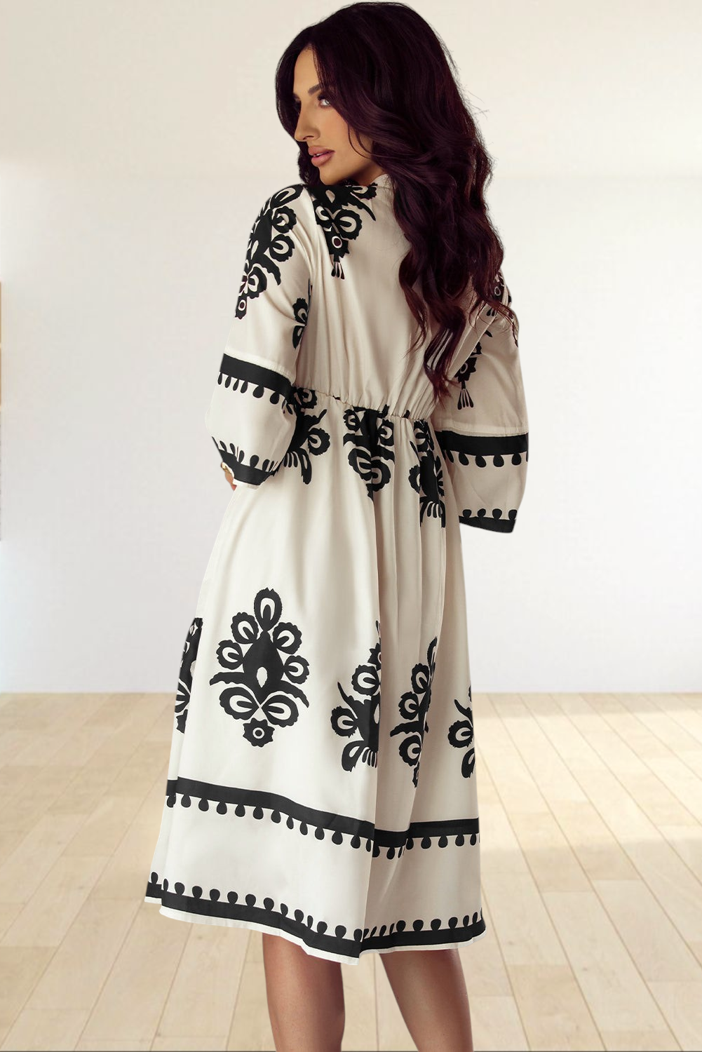 Baya Wear beige midi dress with black geometric print, V-neckline, and 3/4 sleeves worn by a model