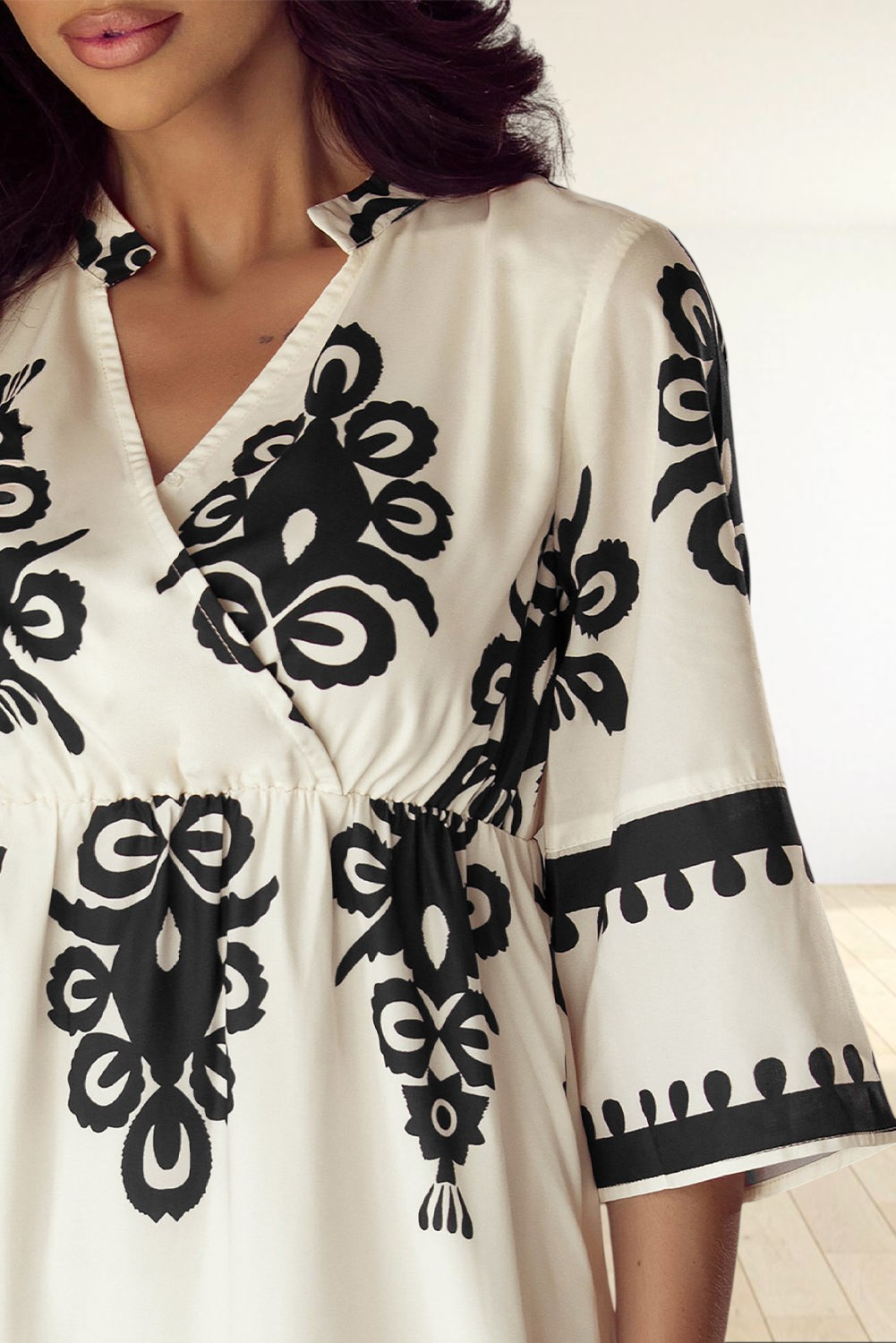 Baya Wear beige midi dress with black geometric western print, V-neckline, and 3/4 sleeves on a model
