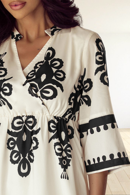 Baya Wear beige midi dress with black geometric western print, V-neckline, and 3/4 sleeves on a model
