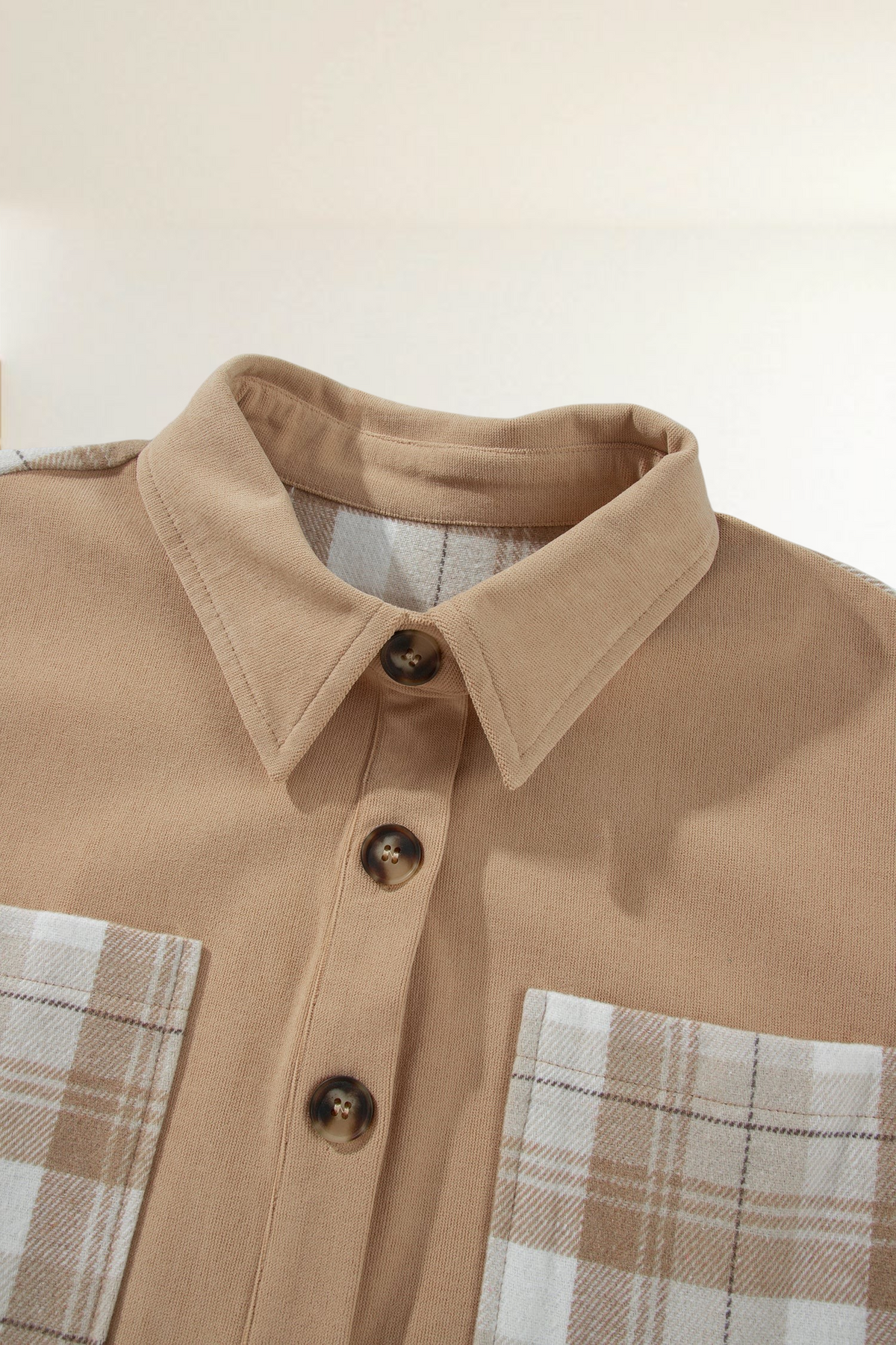 Baya Wear light French beige colorblock shacket with cream and beige plaid panels, collar, and button-front closure.