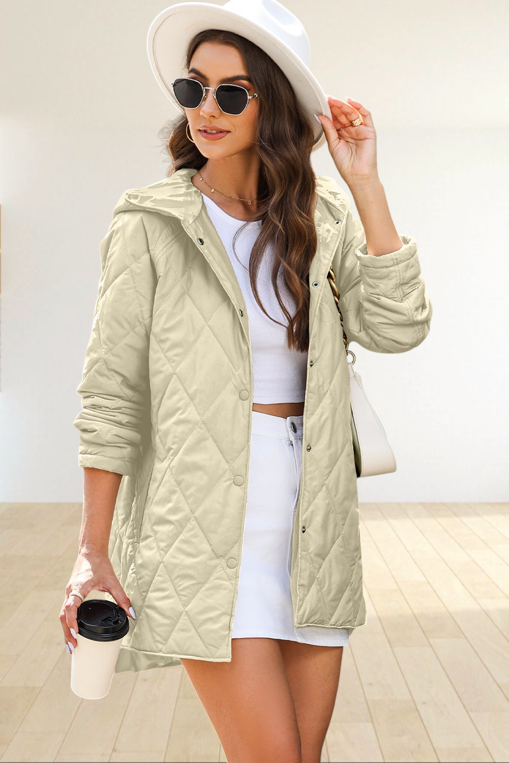 Baya Wear beige diamond-quilted longline hooded jacket with snap buttons worn by a woman with a white hat and glasses