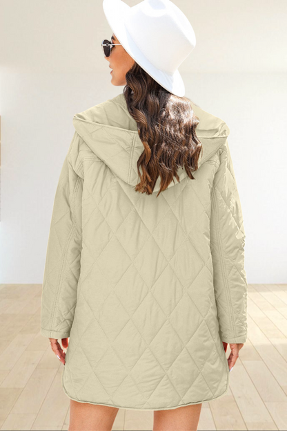 Baya Wear beige diamond-quilted longline hooded jacket with snap buttons, worn by a woman in a white hat.