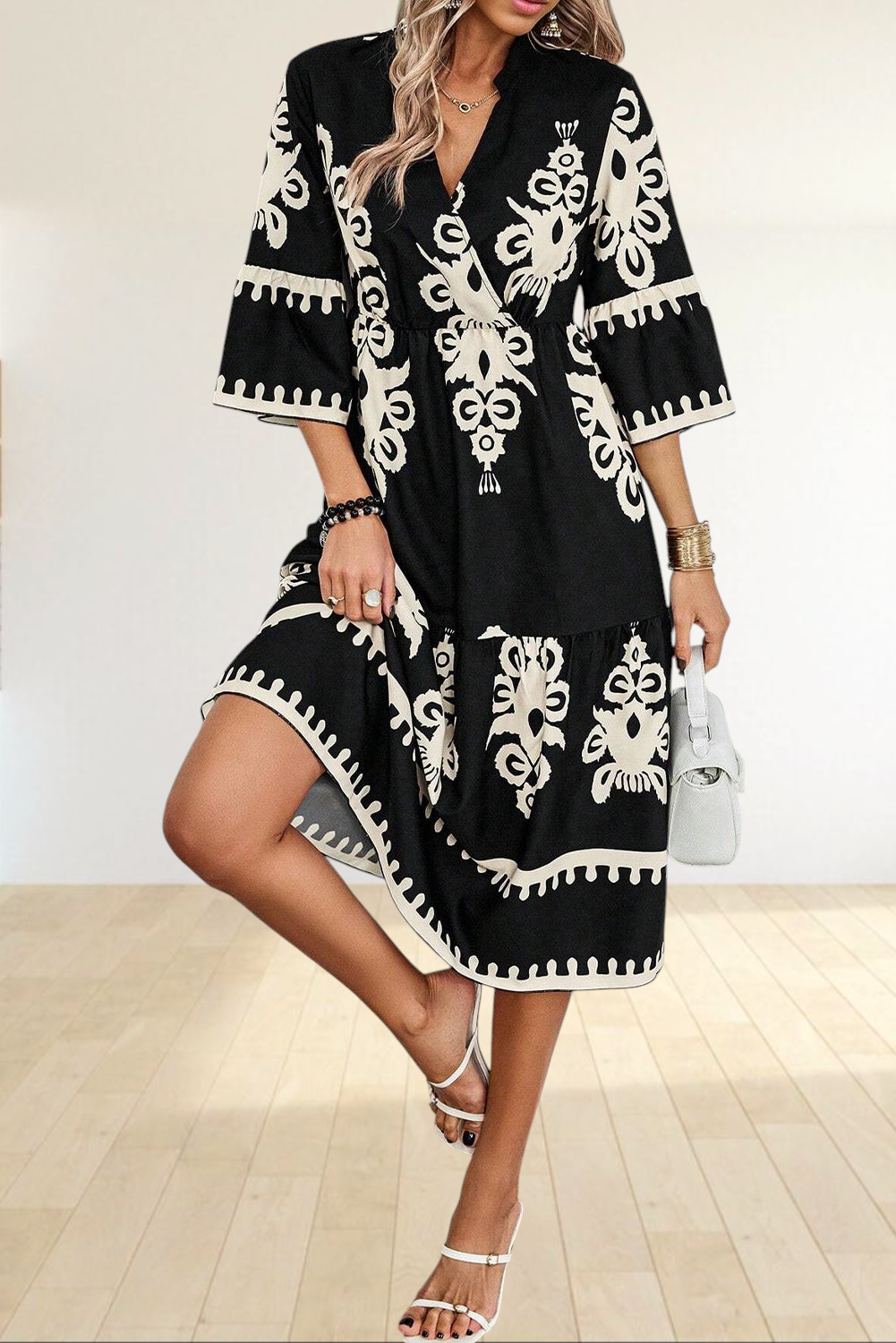 Baya Wear black and beige geometric print midi dress with V-neck, 3/4 sleeves, and tiered skirt on a model.