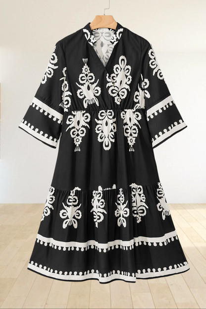 Baya Wear black and white geometric print midi dress with a V-neck, 3/4 sleeves, and a tiered skirt design.