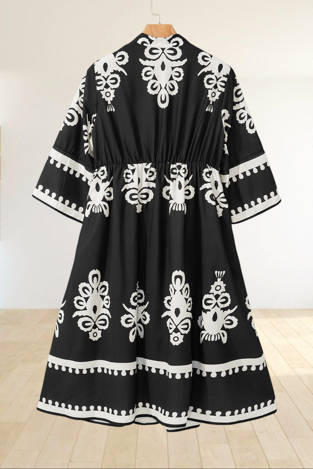 Baya Wear black and white geometric print midi dress with a V-neck, tiered skirt, and 3/4 length sleeves.