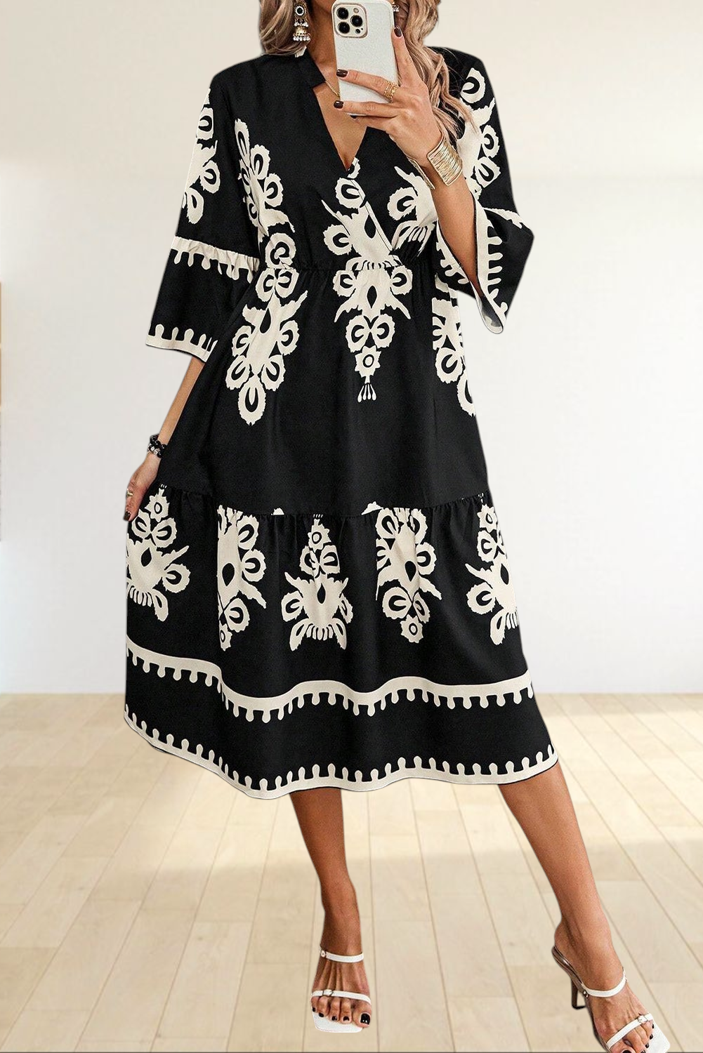 Baya Wear black and white geometric print midi dress with V-neck, tiered skirt, and 3/4 sleeves on a model