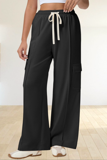 Baya Wear black high-waisted wide-leg cargo sweatpants with side patch pockets and a cream drawstring waist.