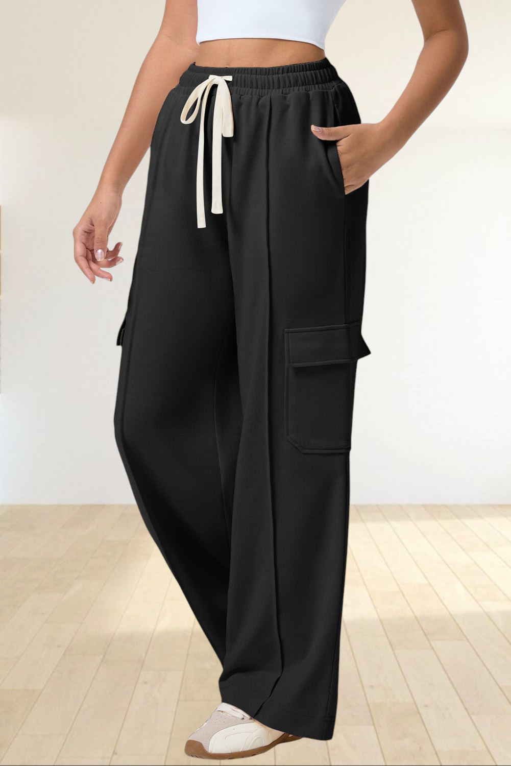 Baya Wear black high-waisted wide-leg cargo sweatpants with side patch pockets and a cream drawstring waist