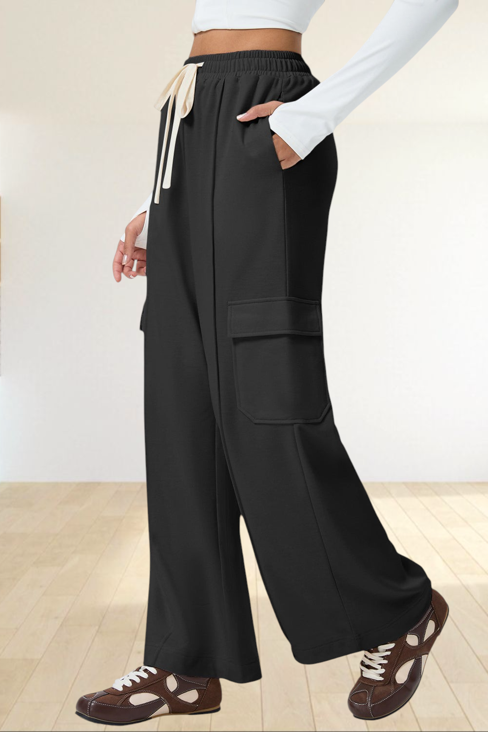 Baya Wear black high-waisted wide-leg cargo sweatpants with side patch pockets and an adjustable drawstring waist.