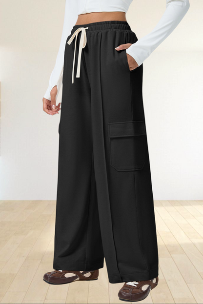 Baya Wear black high-waisted wide-leg cargo sweatpants with side patch pockets and an adjustable drawstring waist.