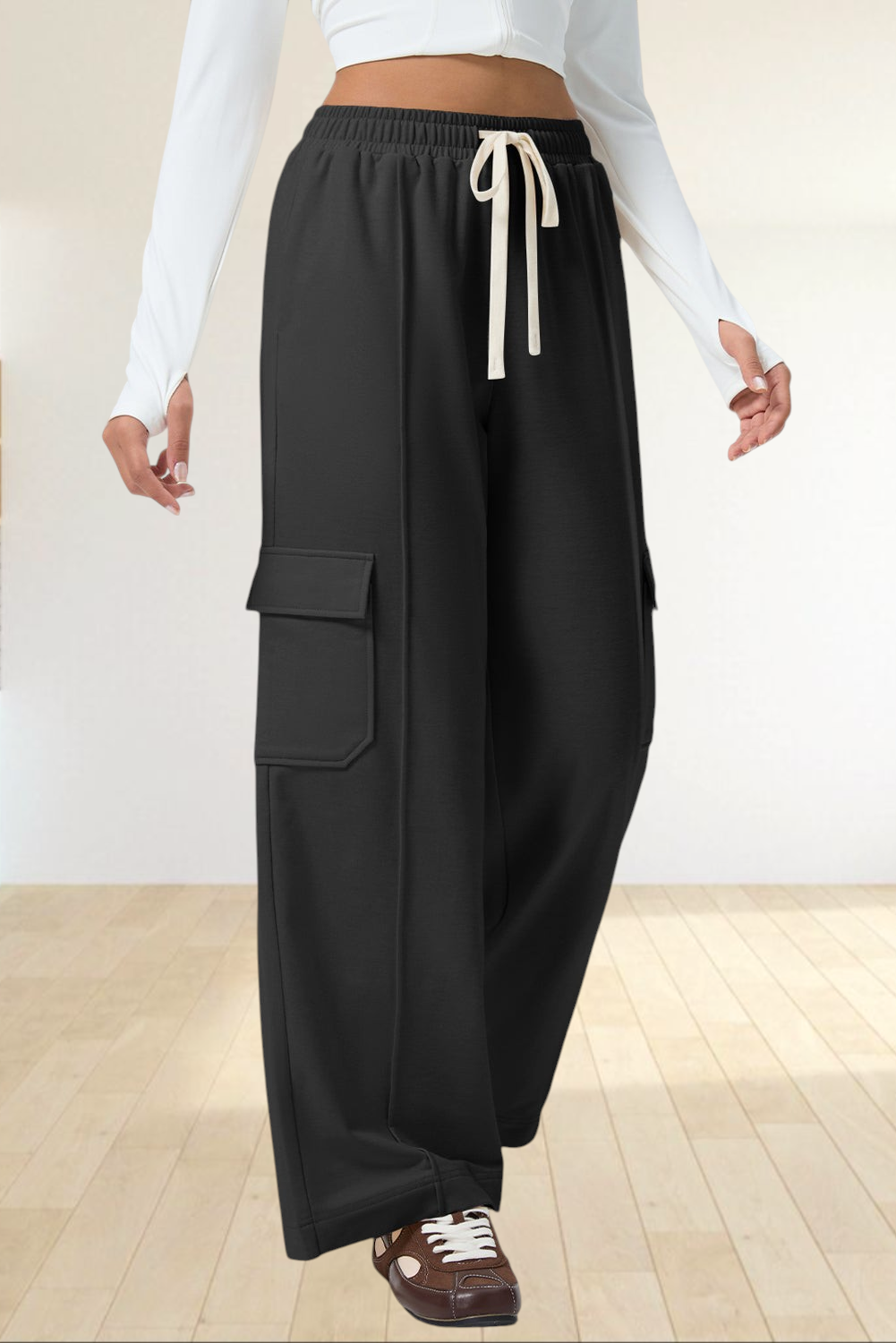 Baya Wear black high-waisted wide-leg cargo sweatpants with side patch pockets and an adjustable drawstring waist.