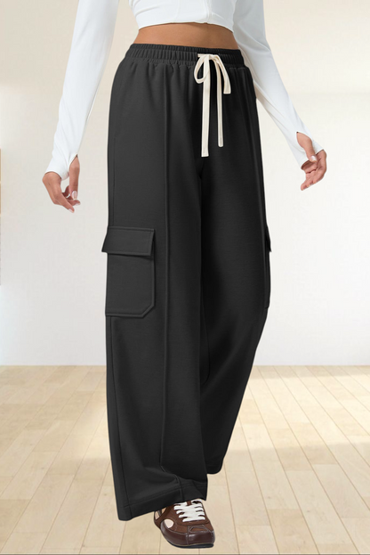 Baya Wear black high-waisted wide-leg cargo sweatpants with side patch pockets and an adjustable drawstring waist.