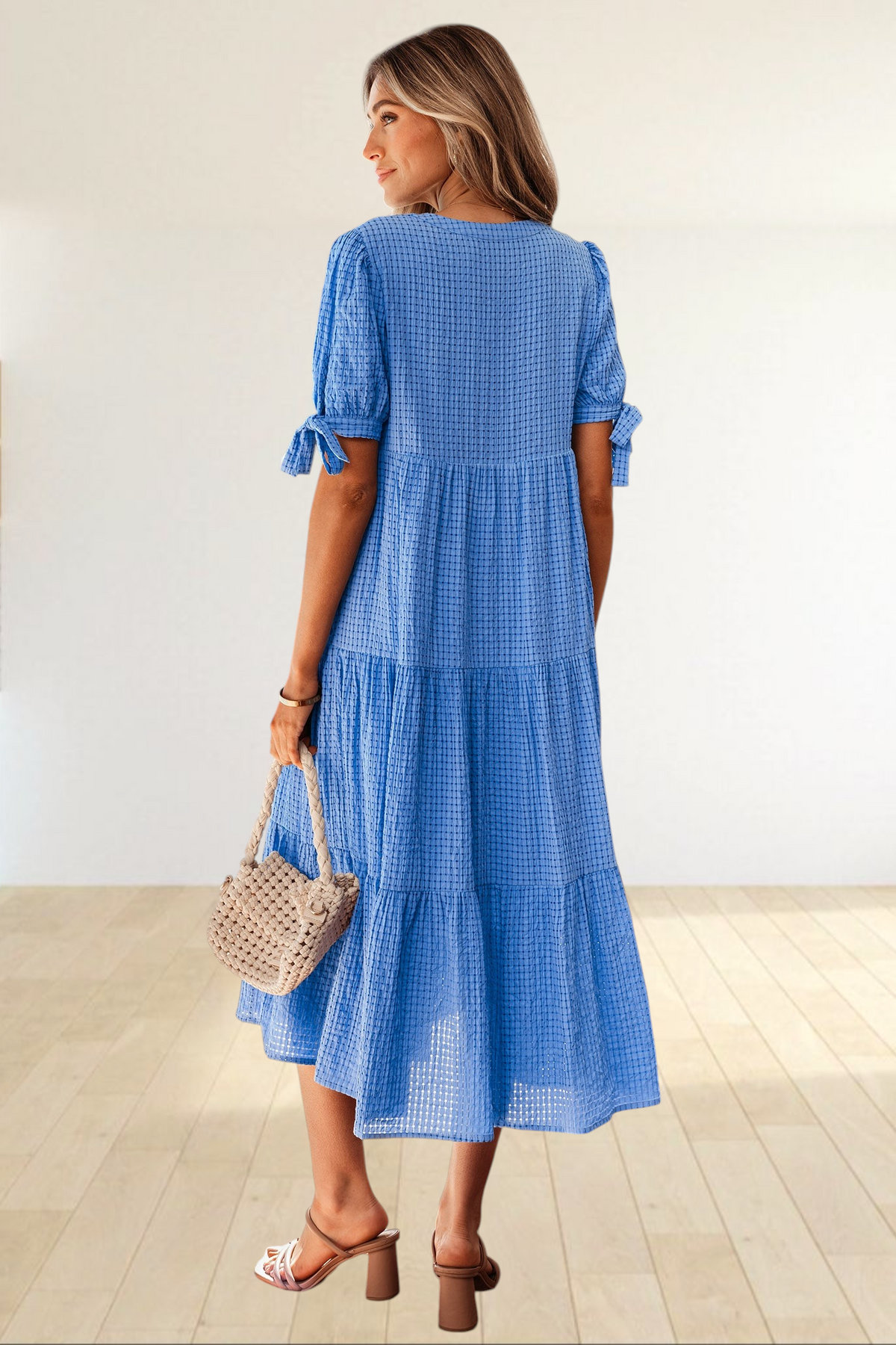 Baya Wear blue textured gingham midi dress with tiered skirt, short sleeves, and bow-tie details, back view.