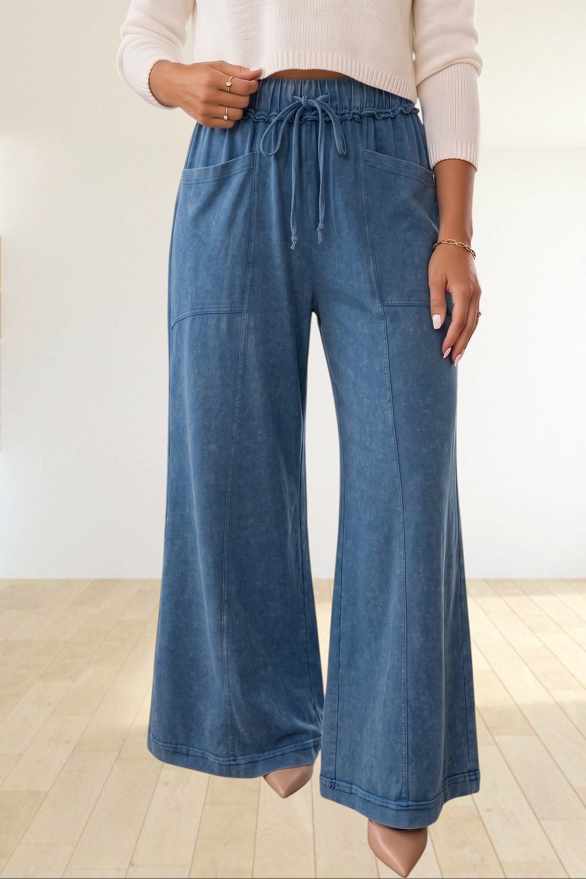 Baya Wear blue mineral wash flare leg lounge pants with a drawstring waist, seam details, and front pockets.