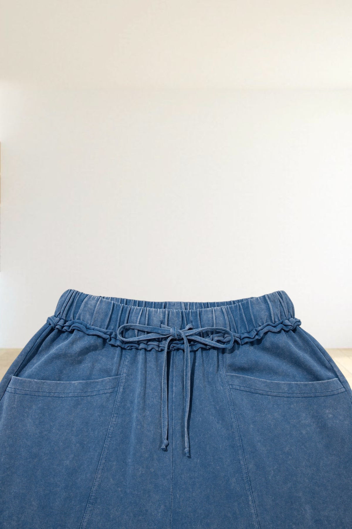 Baya Wear blue mineral wash lounge pants with a drawstring waist, ruffled trim, and side pockets.
