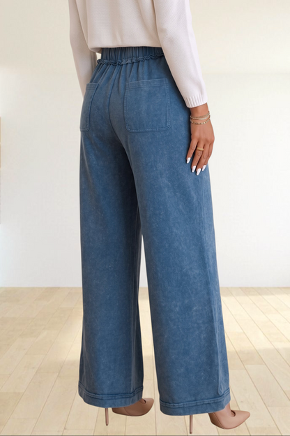Baya Wear blue mineral wash wide leg lounge pants with drawstring waist, back pockets, and seam detail on a model