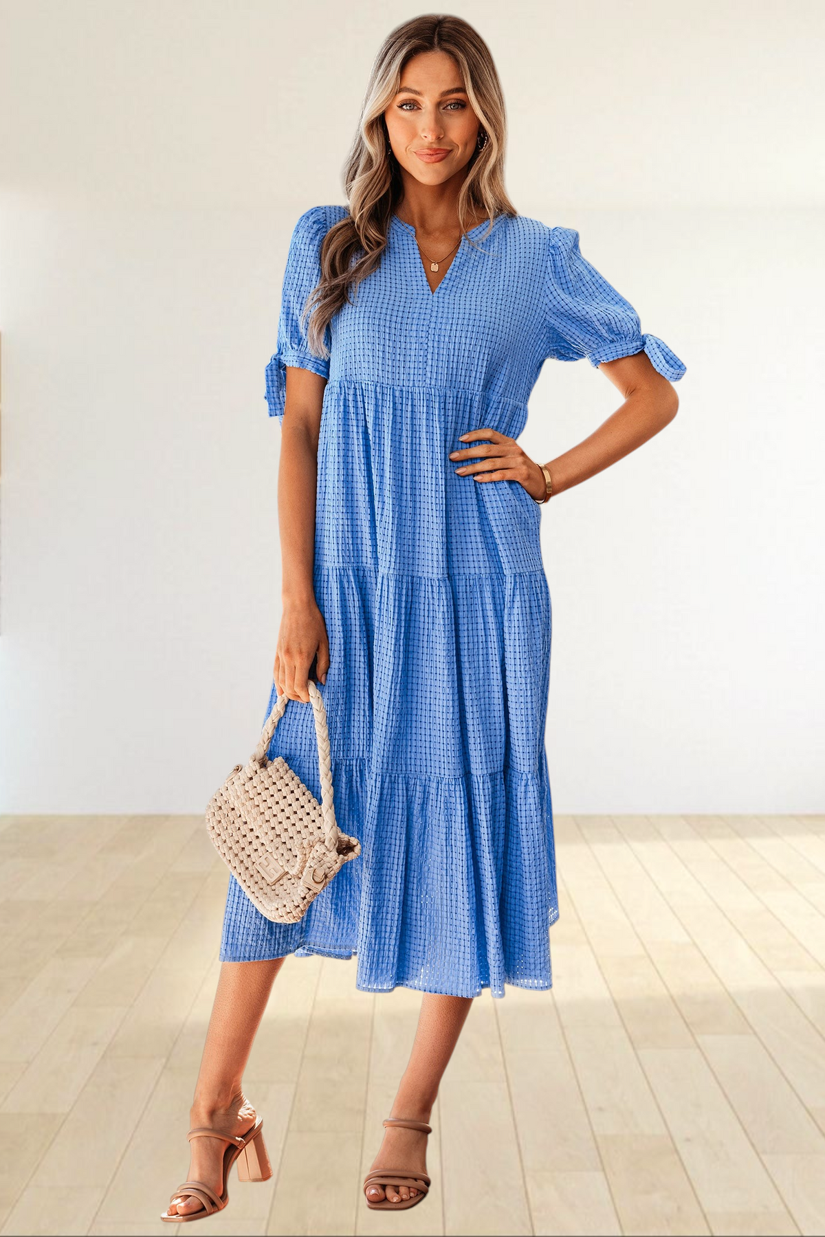 Baya Wear blue textured gingham tiered midi dress with V-neck, short sleeves with bow ties, and side pockets.