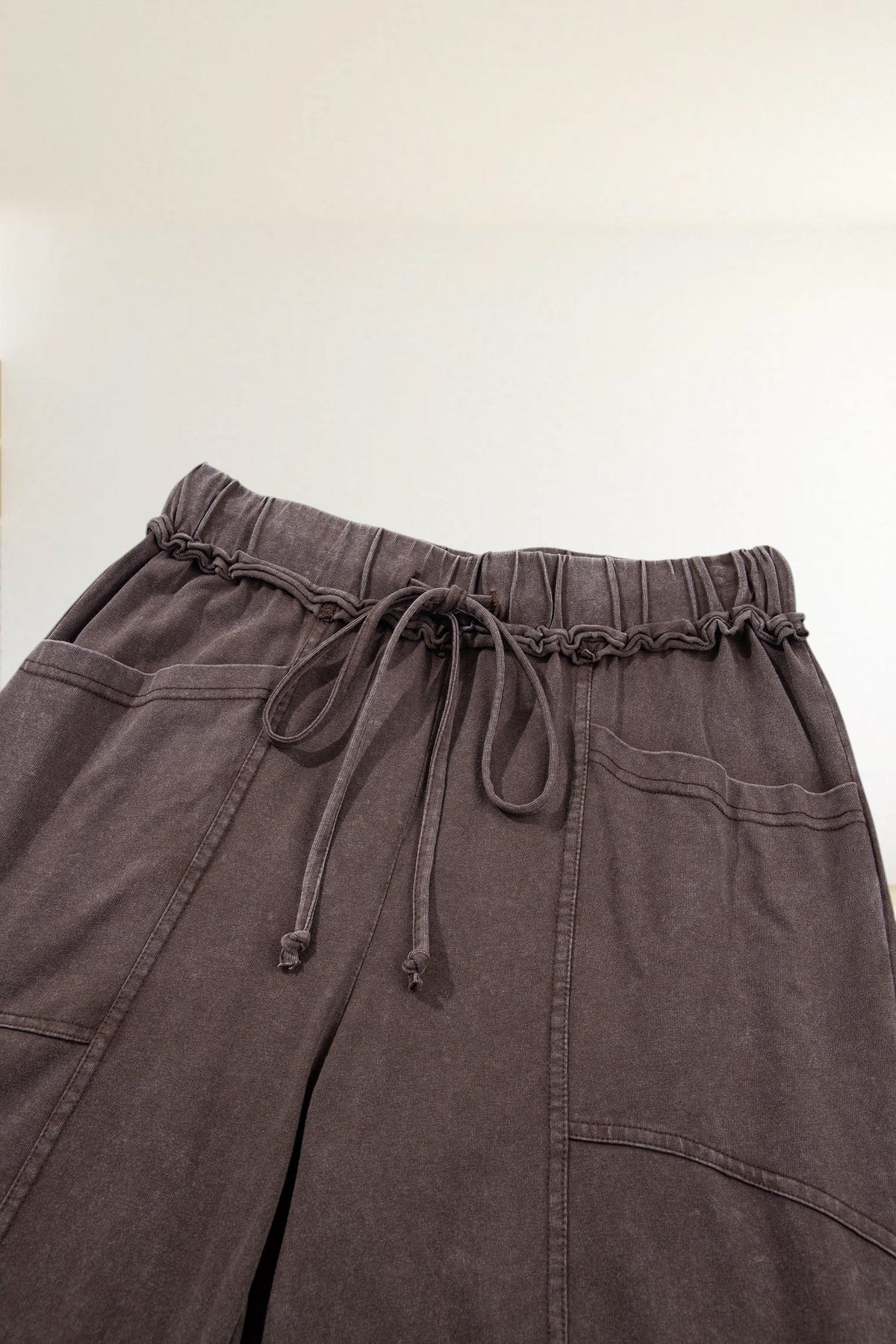 Baya Wear brown mineral wash lounge pants featuring a drawstring elastic waist, seam detailing, and side pockets.