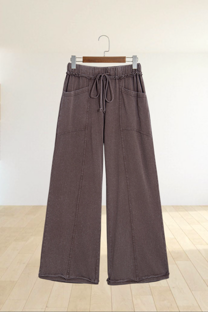 Baya Wear brown mineral wash wide leg lounge pants with a drawstring waist, seam details, and front pockets.