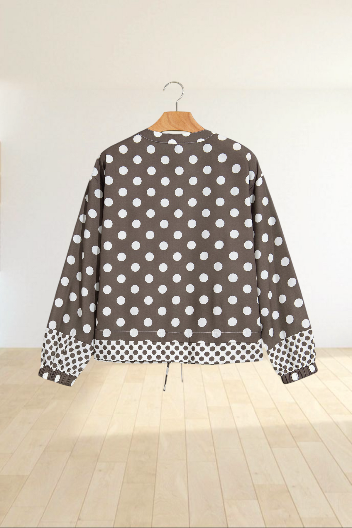 Baya Wear brown bomber jacket with white polka dots, contrast pattern hem and cuffs, and a drawstring waist.