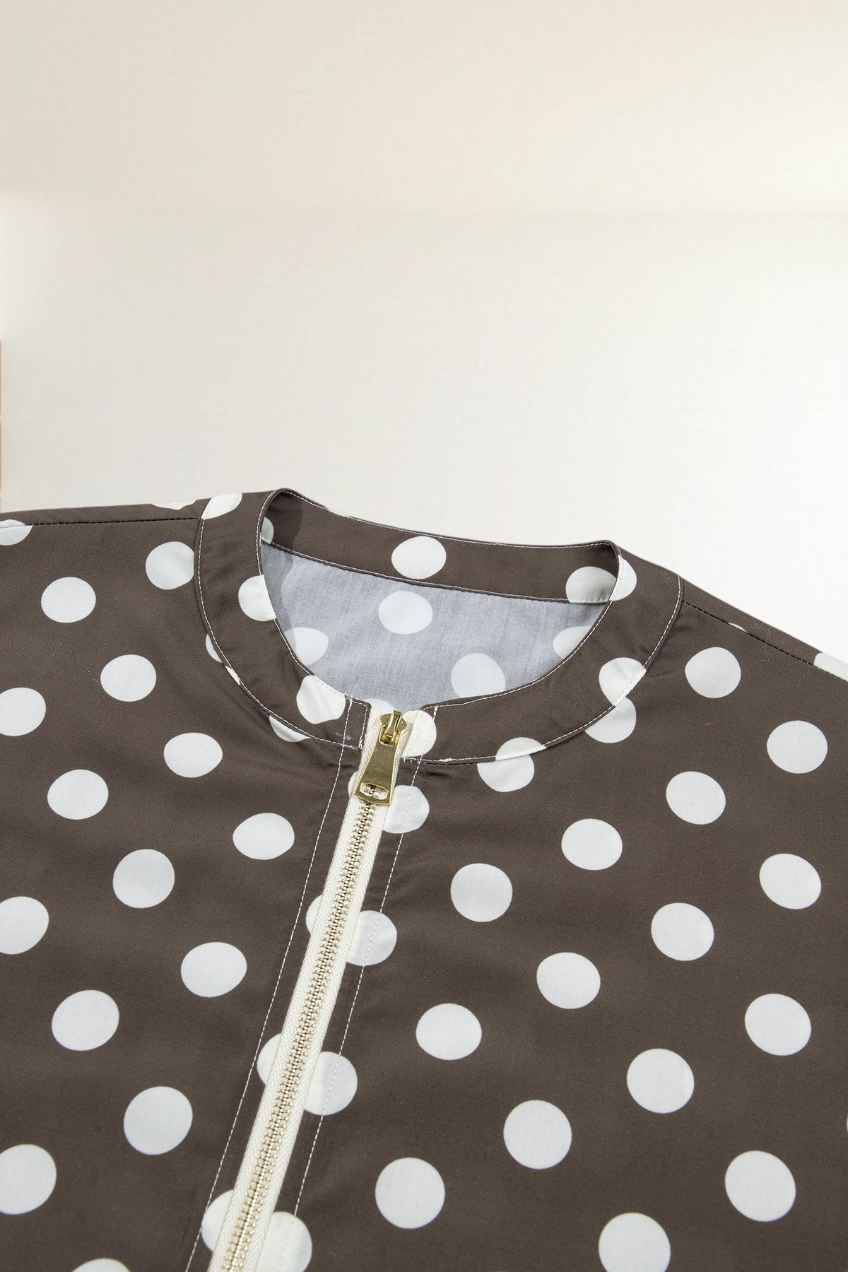 Baya Wear brown bomber jacket with white polka dots, featuring a gold-tone front zipper and round neckline