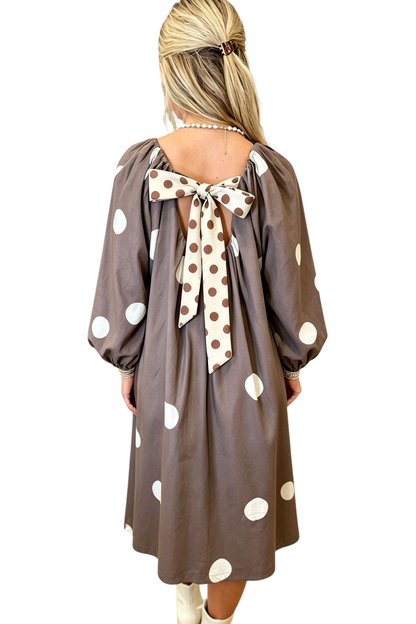 Baya Wear brown midi dress with white polka dots, long sleeves, and a large contrast bow detail on the back