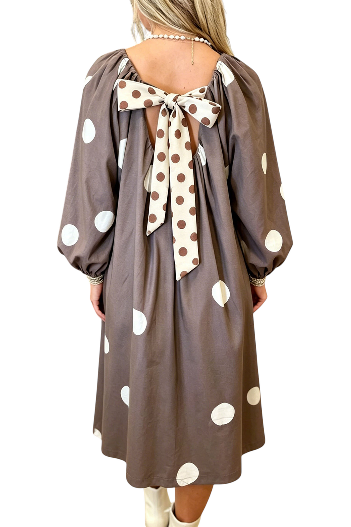 Baya Wear brown midi dress with white polka dots, long sleeves, and a large contrast bow detail on the open back.