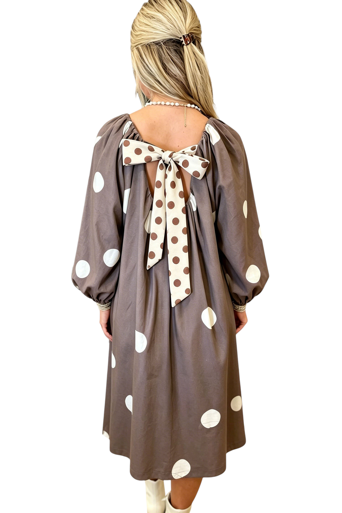 Baya Wear brown midi dress with white polka dots, long sleeves, and a large contrast bow detail on the open back.