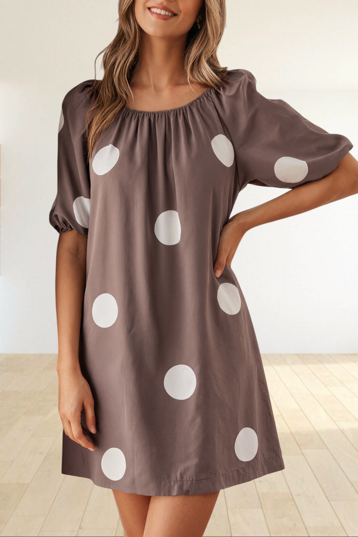 Baya Wear brown mini dress with white polka dots, featuring a gathered neckline and short puff sleeves.