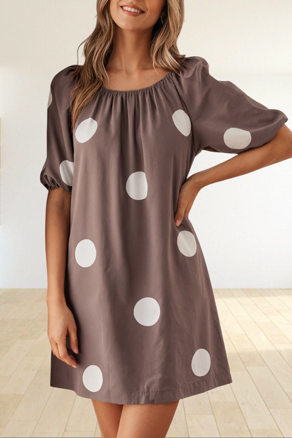 Baya Wear brown mini dress with white polka dots, featuring a gathered neckline and short puff sleeves.