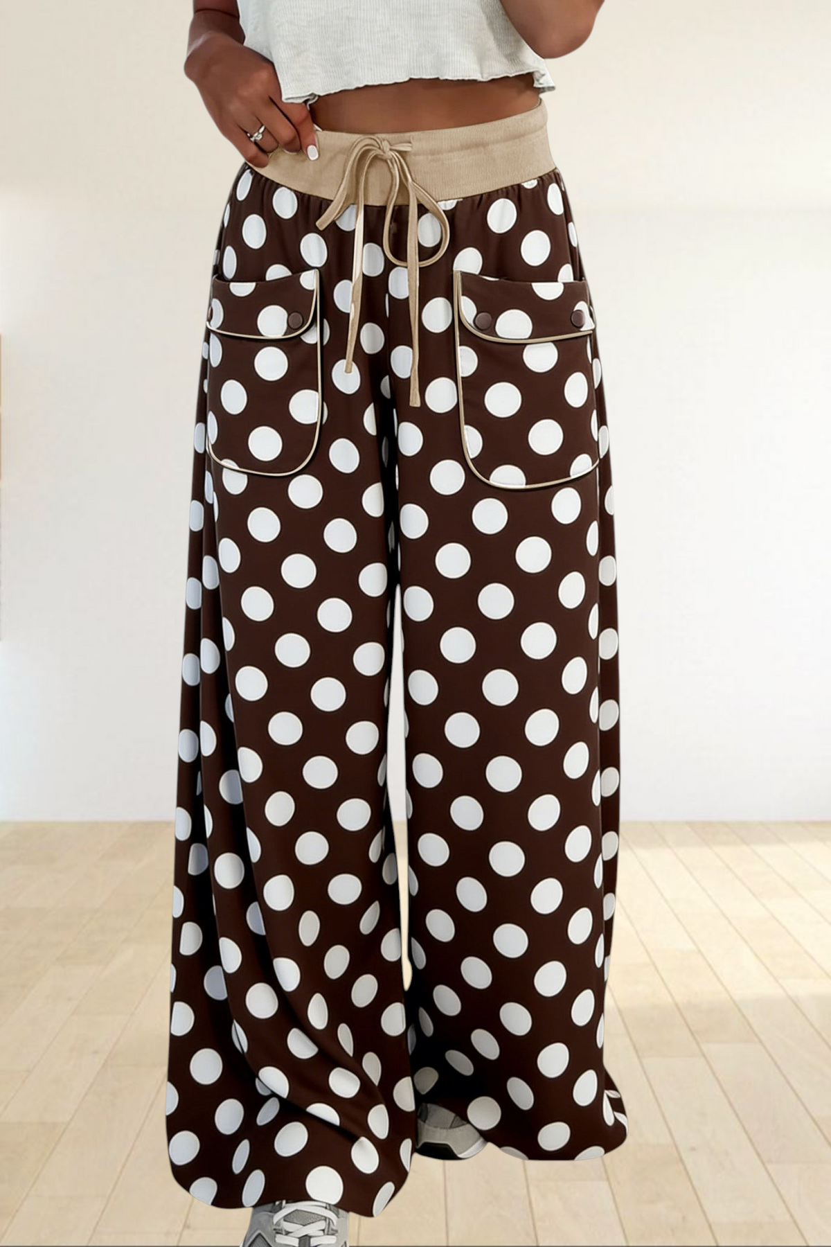 Baya Wear brown wide-leg trousers featuring a white polka dot print, drawstring waist, and piped front patch pockets.