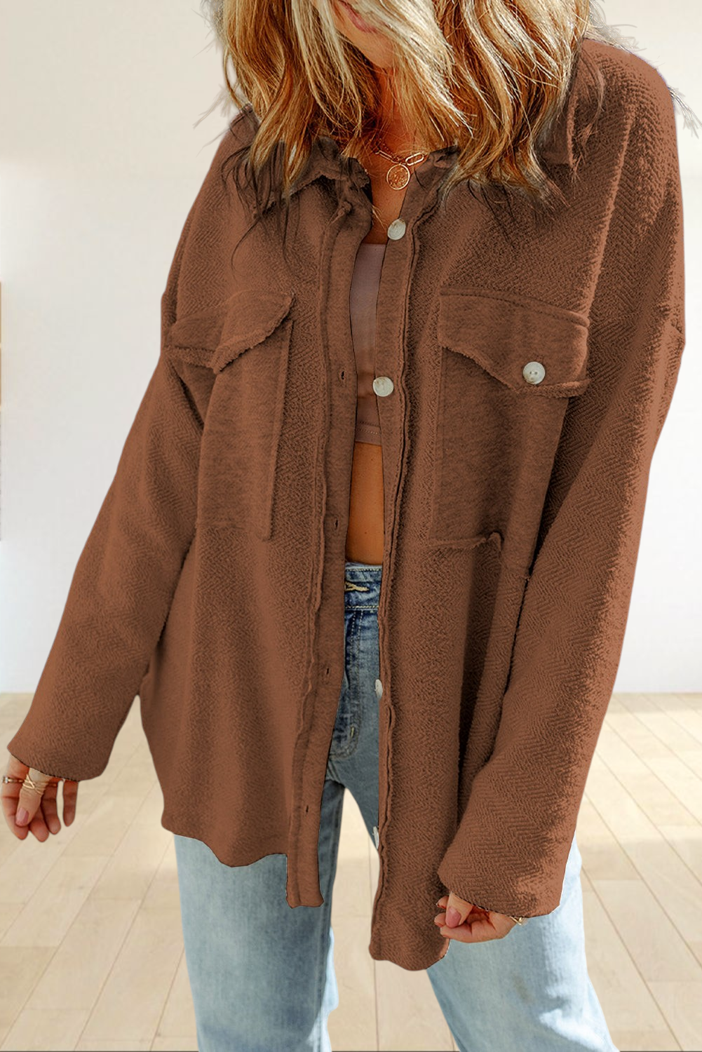Baya Wear brown textured shacket with chest flap pockets, button-down front, and raw-edge detailing on a model.