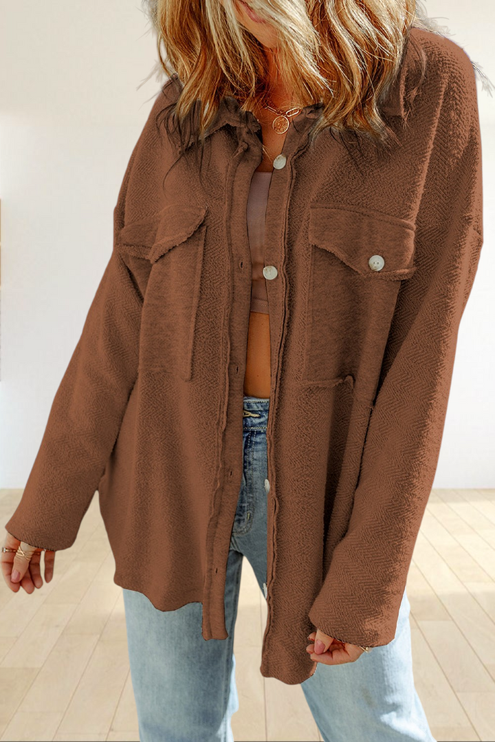 Baya Wear brown textured shacket with chest flap pockets, button-down front, and raw-edge detailing on a model.