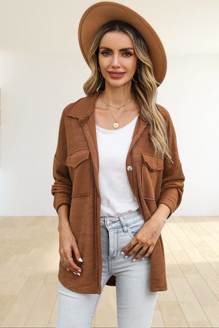Baya Wear brown textured shacket with chest flap pockets and raw-edge details worn by a woman in a felt hat