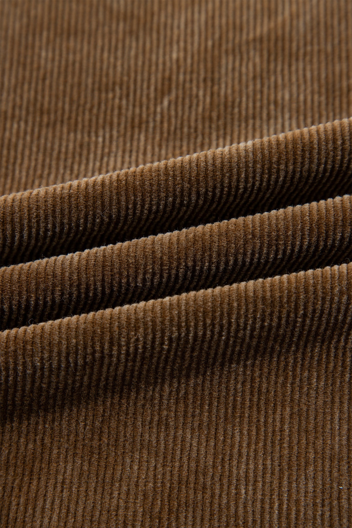 Close-up of Baya Wear camel brown corduroy fabric showing the soft, textured vertical ribbed pattern.