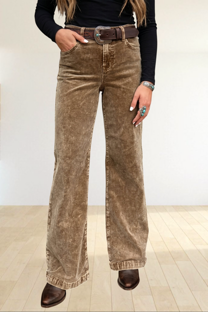 Baya Wear high rise camel corduroy wide leg pants with a western belt, styled in a rustic setting.
