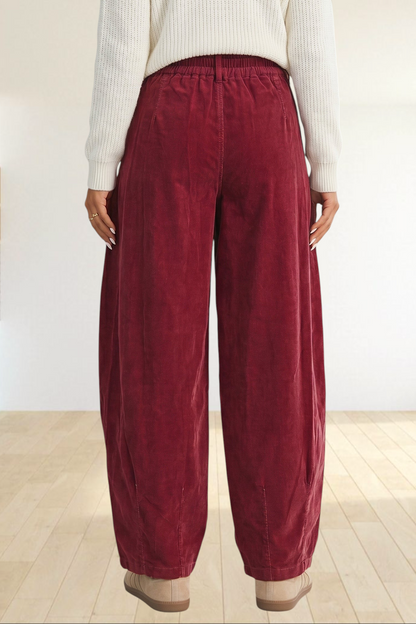 Baya Wear chestnut corduroy trousers with a relaxed wide-leg fit, elastic waistband, and back view on a model.