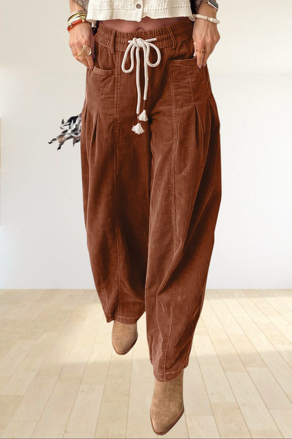 Baya Wear chestnut corduroy trousers featuring a relaxed wide-leg fit, elastic drawstring waist, and side pockets.