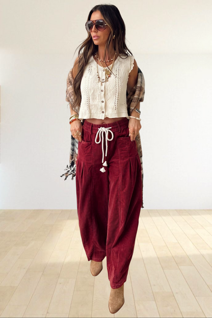 Baya Wear chestnut corduroy trousers with a wide-leg fit, elastic drawstring waist, and side pockets on a model.
