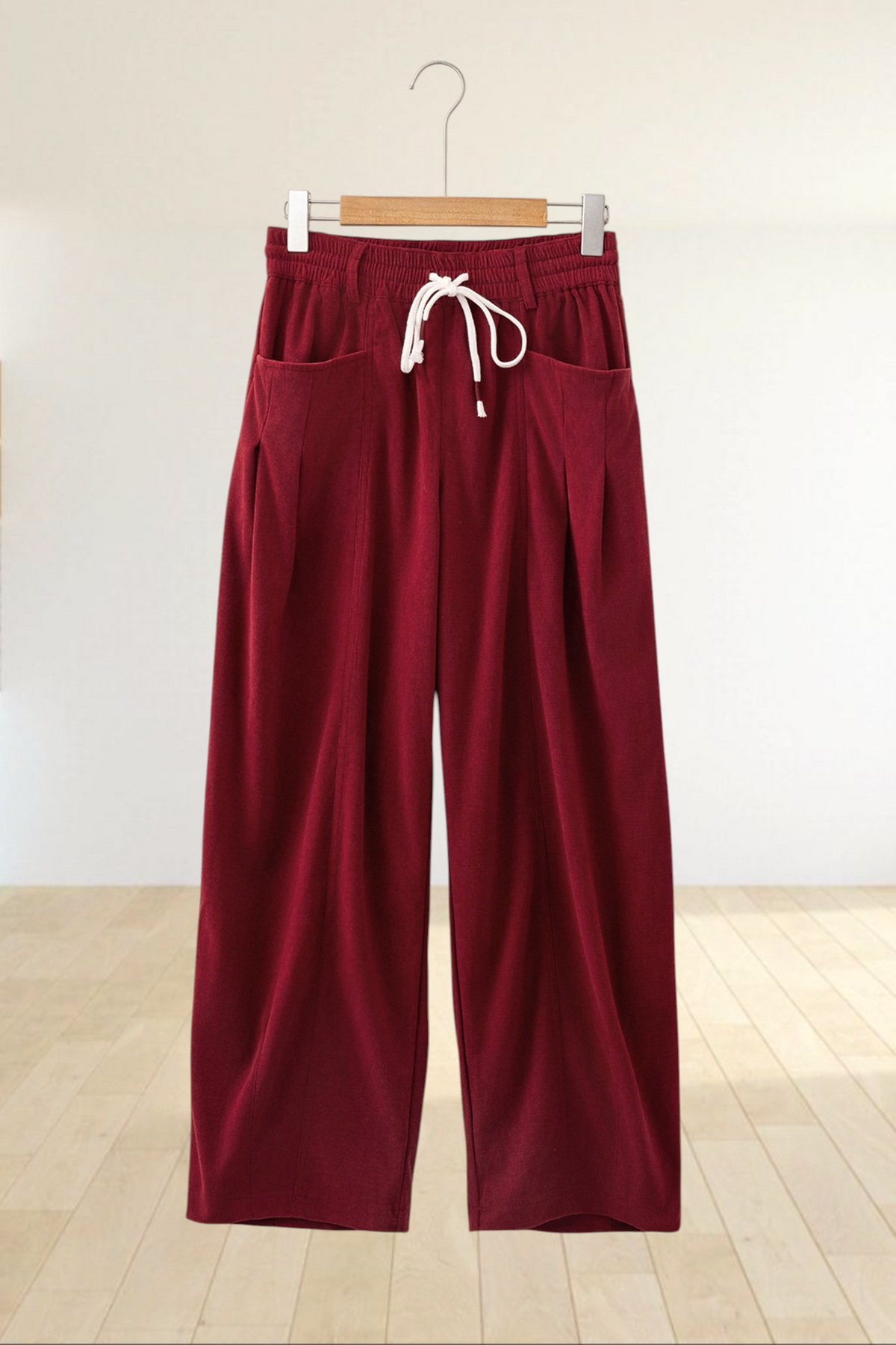 Baya Wear chestnut corduroy trousers with a relaxed wide-leg fit, elastic drawstring waist, and side pockets.