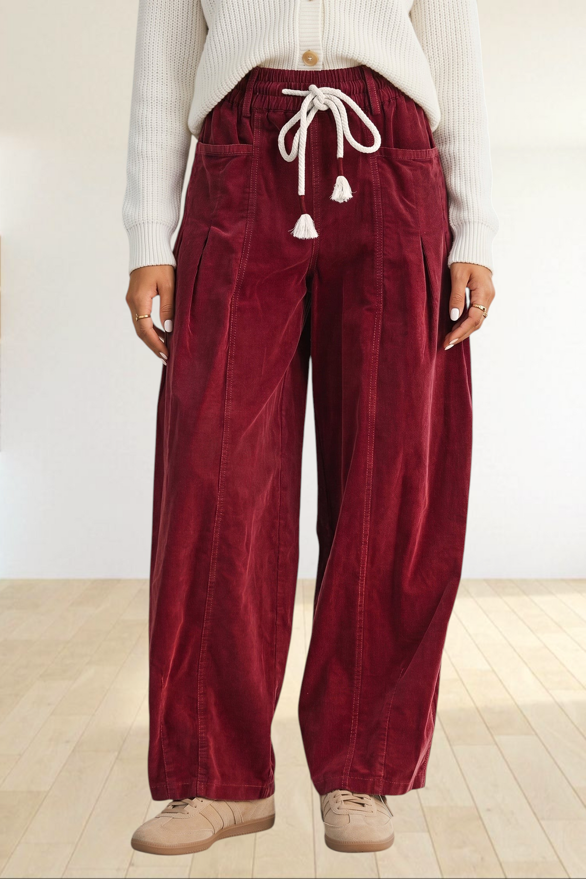 Baya Wear chestnut corduroy wide-leg trousers with an elastic drawstring waist and tassel details.