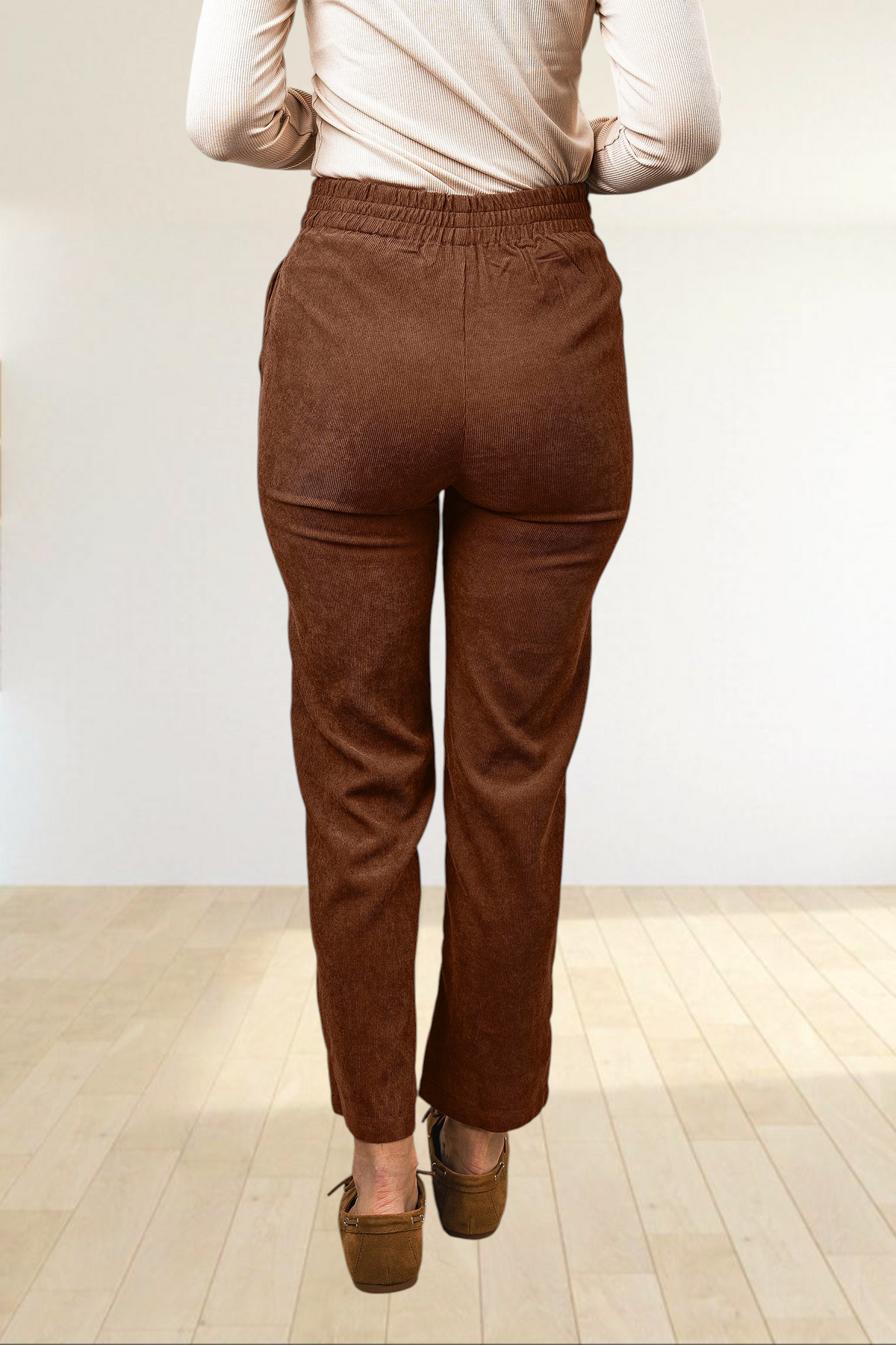 Baya Wear coffee brown corduroy straight leg trousers with an elastic back waistband, viewed from the back.