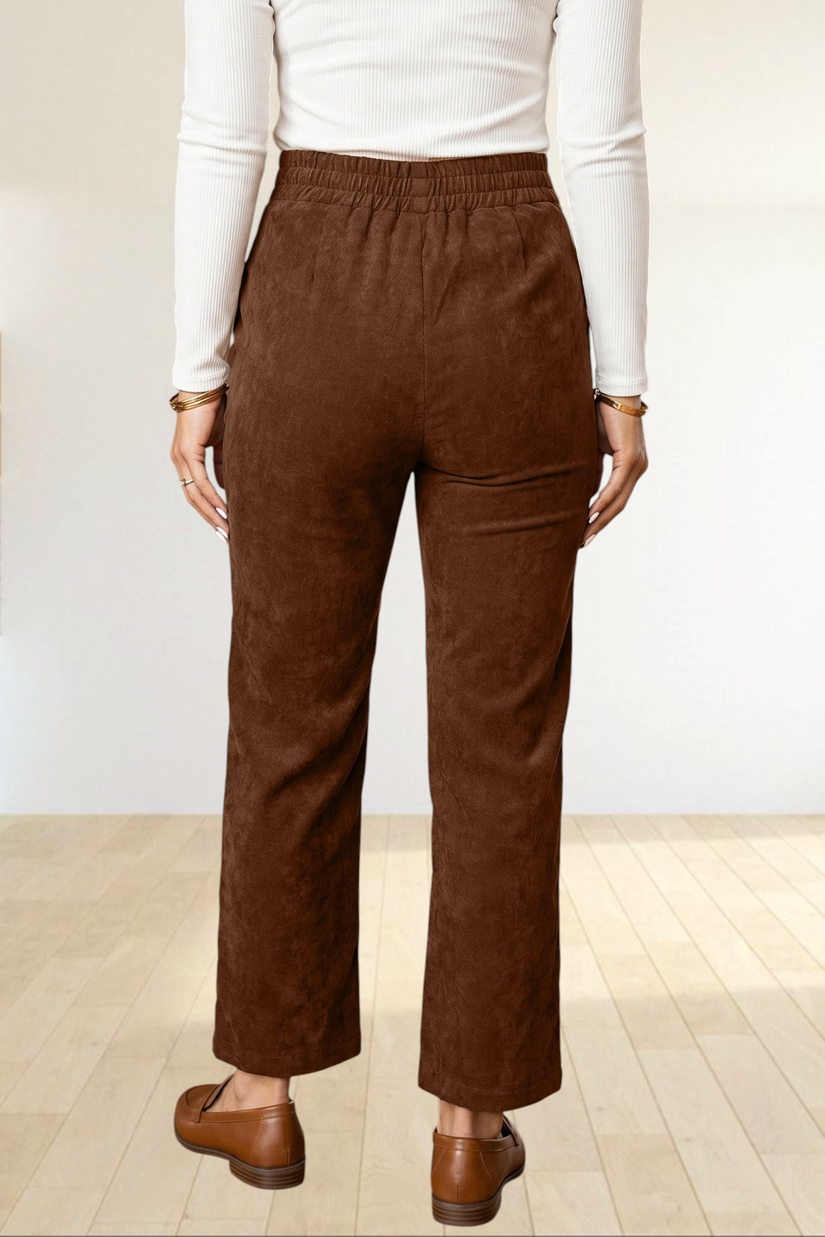 Baya Wear coffee brown corduroy straight leg trousers with an elastic back waistband, viewed from the back.